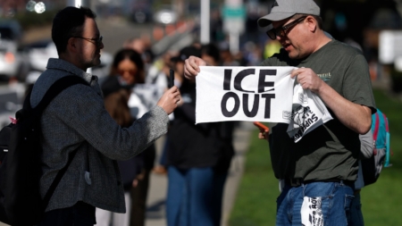 Activists Hand Out ‘ICE OUT’ Towels at Super Bowl LX